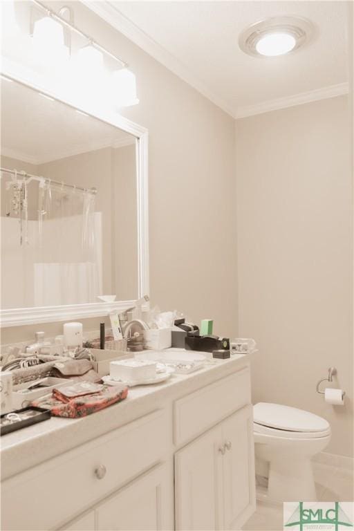 bathroom with tile patterned flooring, vanity, toilet, and ornamental molding