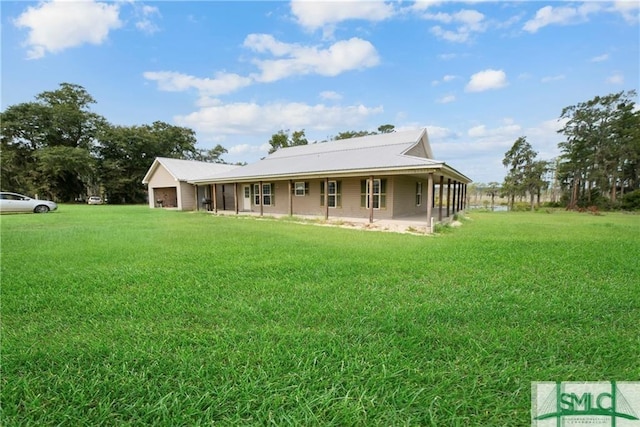 rear view of property with a yard and a porch