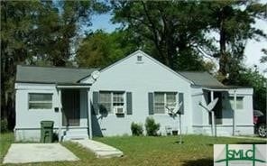 rear view of house with a lawn