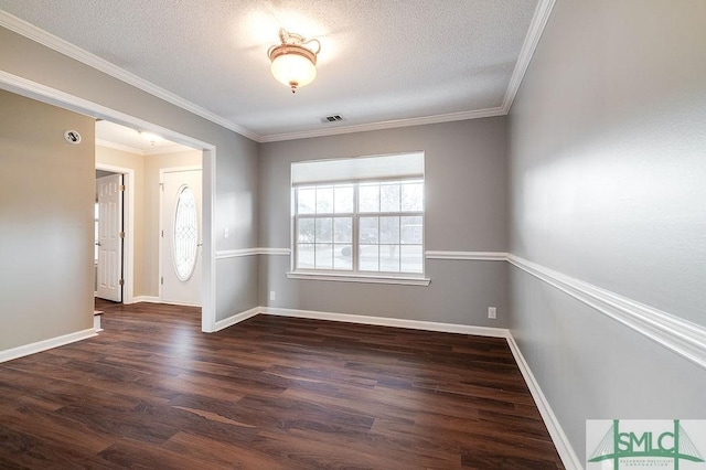 spare room featuring a textured ceiling, crown molding, and dark wood-type flooring