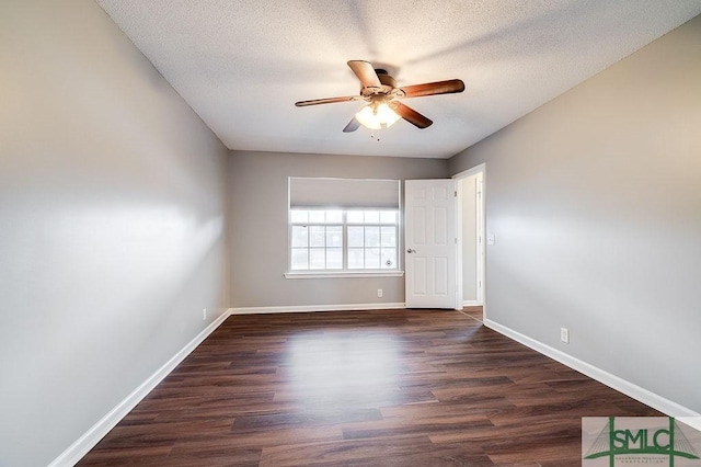 spare room featuring a textured ceiling, ceiling fan, and dark wood-type flooring