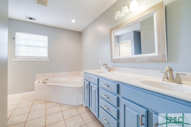 bathroom featuring tile patterned flooring, vanity, and a tub to relax in