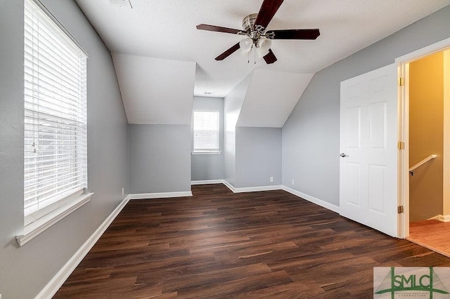 bonus room with dark hardwood / wood-style floors, ceiling fan, and vaulted ceiling