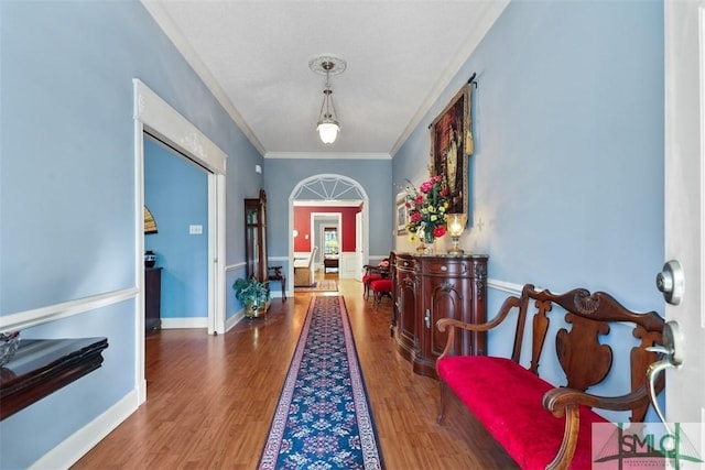 corridor featuring ornamental molding and dark hardwood / wood-style floors