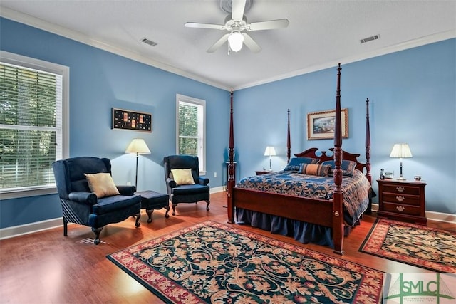 bedroom with hardwood / wood-style floors, multiple windows, ceiling fan, and crown molding