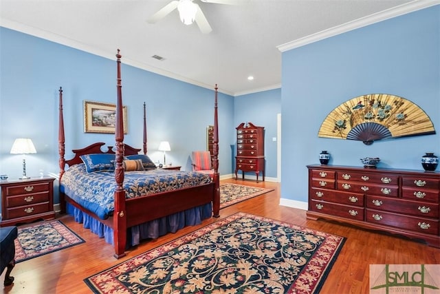 bedroom featuring ornamental molding, ceiling fan, and hardwood / wood-style floors