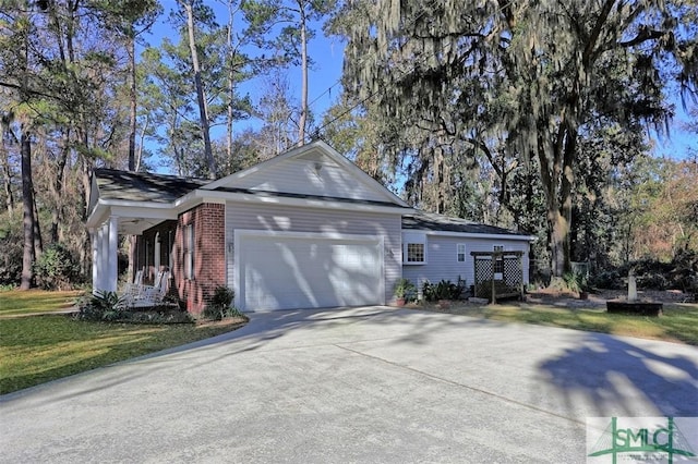 view of side of home featuring a lawn and a garage