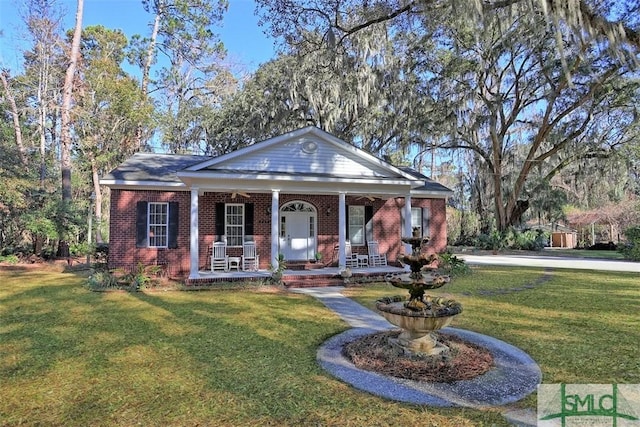 greek revival house with covered porch and a front lawn