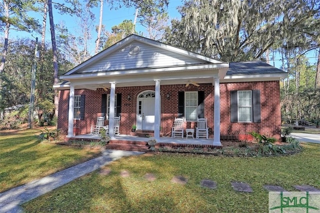 view of front of property with covered porch and a front lawn