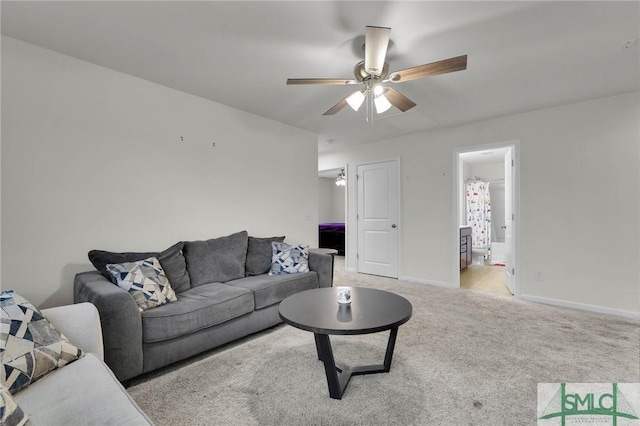 carpeted living room with ceiling fan