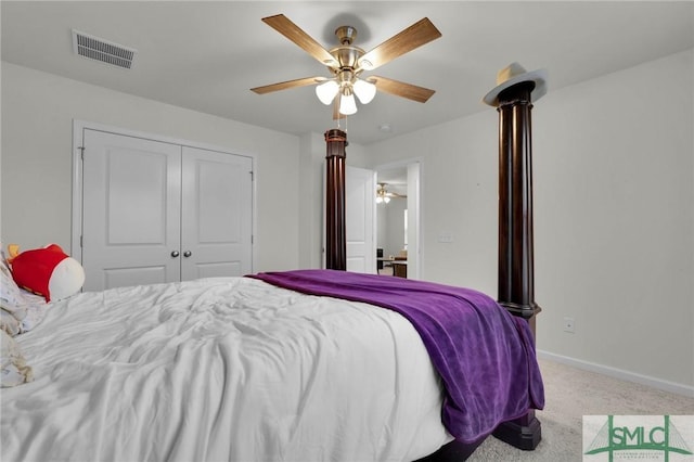 carpeted bedroom featuring ceiling fan and a closet