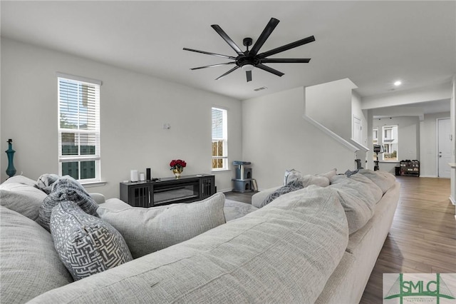 living room featuring dark hardwood / wood-style floors, a wealth of natural light, and ceiling fan