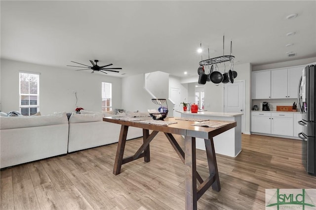 kitchen featuring white cabinetry, plenty of natural light, stainless steel fridge, and light hardwood / wood-style floors