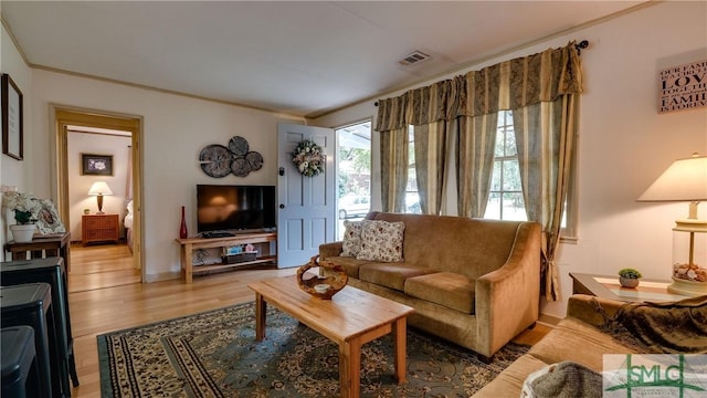 living room featuring hardwood / wood-style floors and ornamental molding