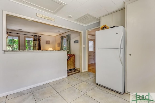 kitchen with white refrigerator and light tile patterned floors