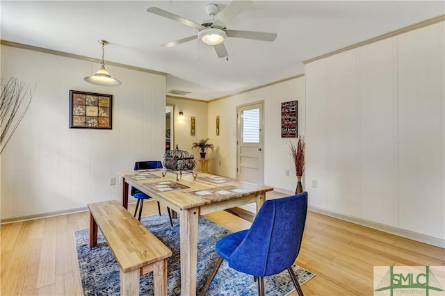 dining room featuring ceiling fan, ornamental molding, and light hardwood / wood-style flooring