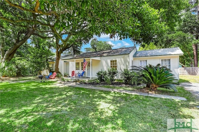 ranch-style home with covered porch and a front yard