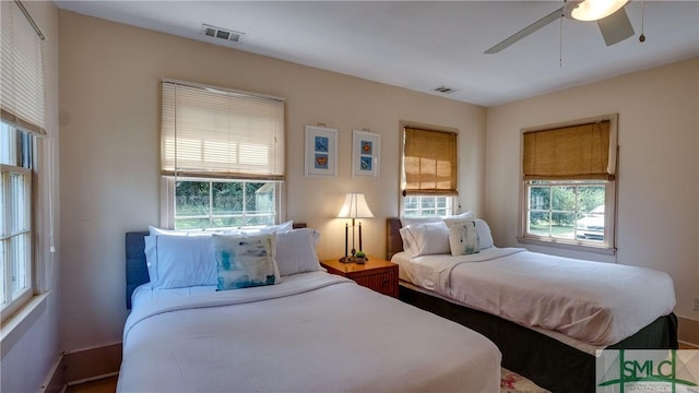 bedroom with multiple windows and ceiling fan