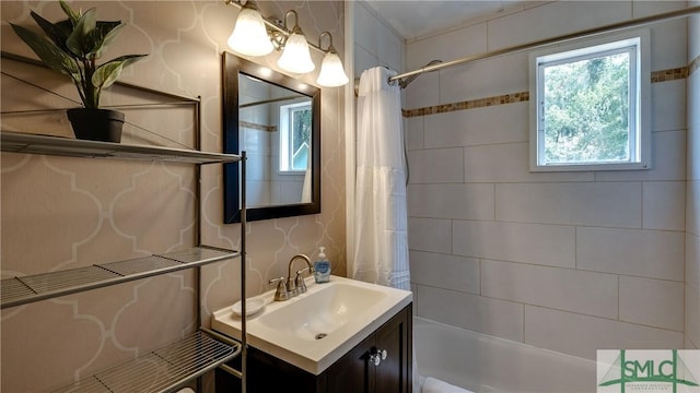 bathroom featuring shower / bath combo with shower curtain and vanity