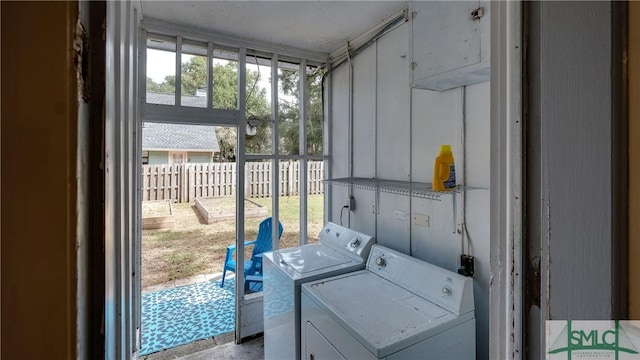 clothes washing area with washer and clothes dryer