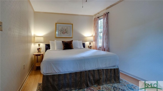 bedroom with crown molding and light hardwood / wood-style flooring