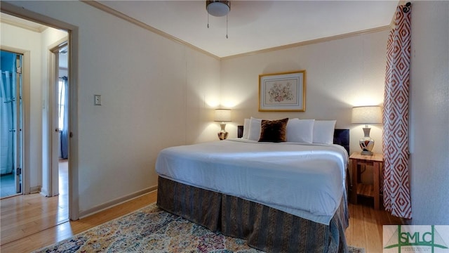 bedroom with light hardwood / wood-style flooring, ceiling fan, and crown molding