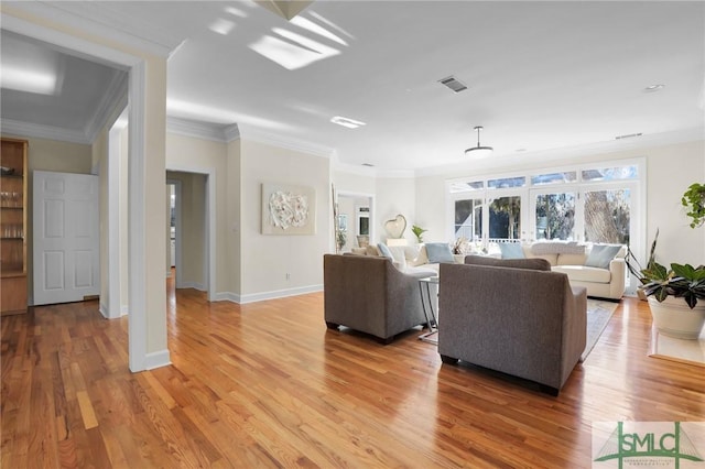 living room featuring crown molding, light hardwood / wood-style flooring, and french doors