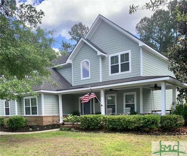 view of front facade featuring covered porch, ceiling fan, and a front yard