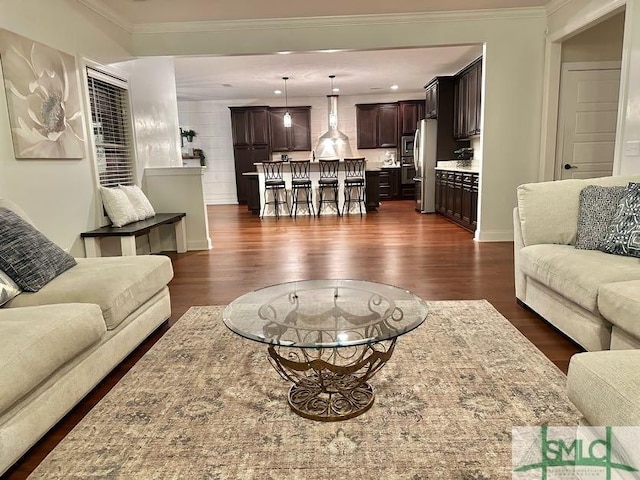 living room with dark hardwood / wood-style flooring and ornamental molding