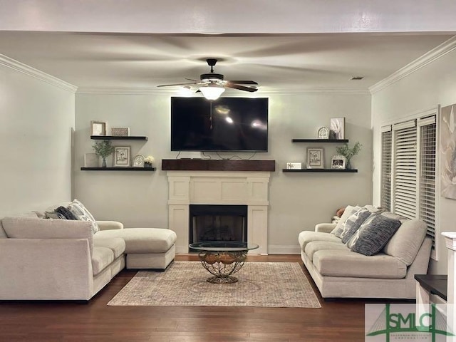 living room featuring dark hardwood / wood-style flooring, ceiling fan, and ornamental molding