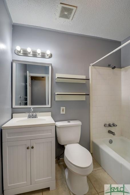 full bathroom featuring vanity, tile patterned flooring, tiled shower / bath combo, toilet, and a textured ceiling