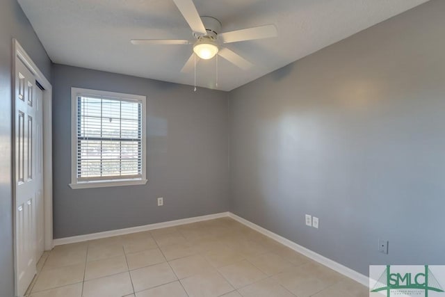 tiled empty room with ceiling fan