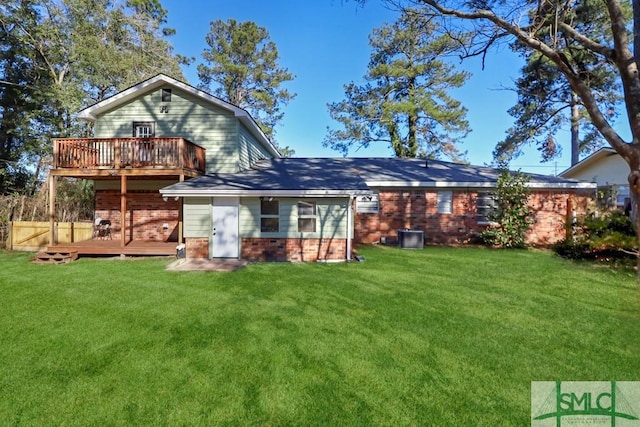 rear view of house with a yard and a deck