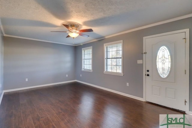 entryway with a textured ceiling, plenty of natural light, crown molding, and ceiling fan