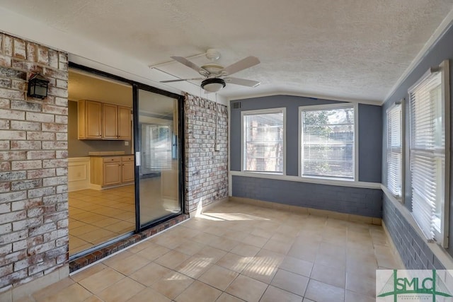 unfurnished sunroom with ceiling fan and lofted ceiling