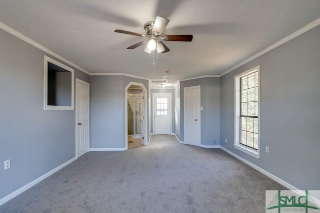 unfurnished bedroom with ceiling fan, light colored carpet, and ornamental molding