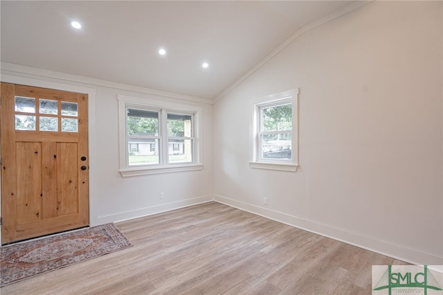 foyer featuring lofted ceiling and light wood-type flooring