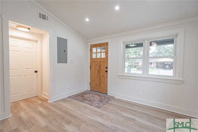 entrance foyer with light wood-type flooring, electric panel, and vaulted ceiling