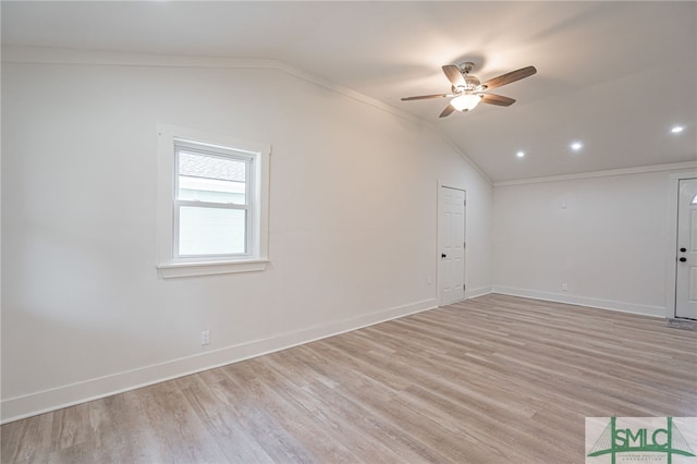 unfurnished room featuring light wood-type flooring, vaulted ceiling, ceiling fan, and ornamental molding