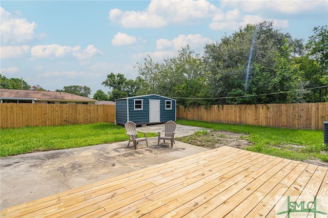 deck featuring a patio, a shed, and a lawn