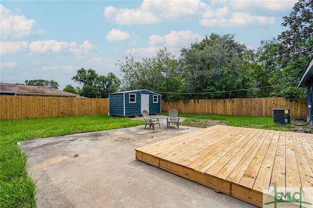 deck with a yard, a patio, central AC unit, and a storage unit