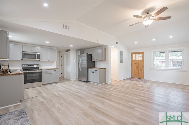 kitchen featuring appliances with stainless steel finishes, lofted ceiling, ceiling fan, and gray cabinetry