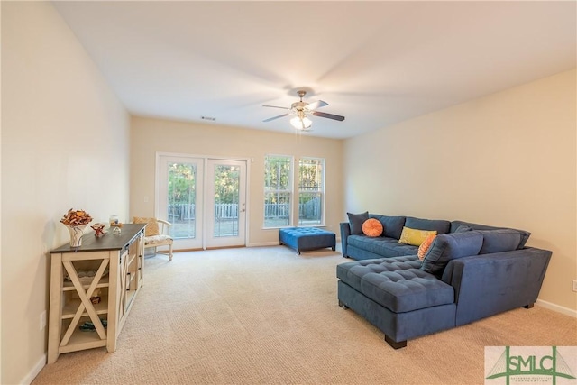 carpeted living room featuring ceiling fan