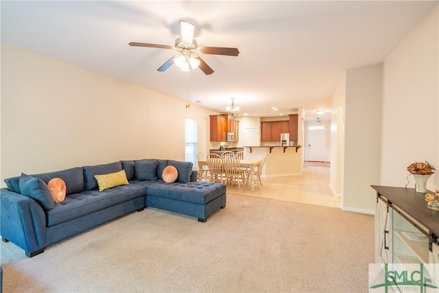 living room with ceiling fan and light colored carpet