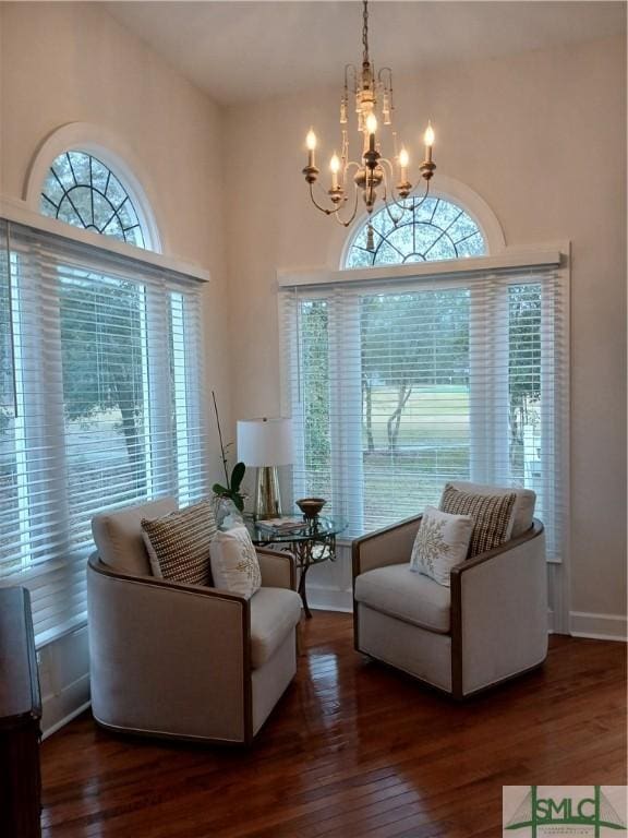 living room with dark hardwood / wood-style flooring and a notable chandelier