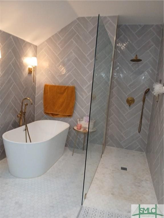 bathroom with separate shower and tub and tile walls