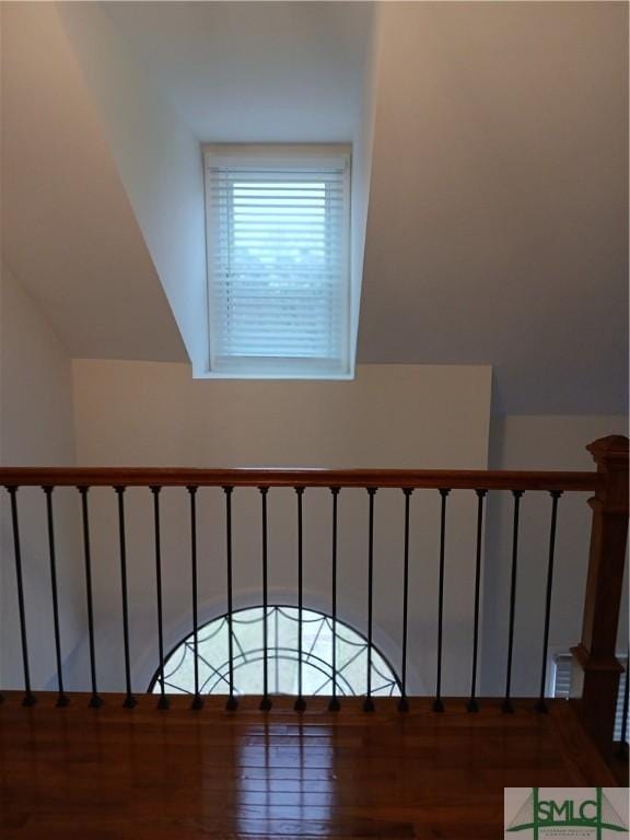 staircase with hardwood / wood-style flooring and lofted ceiling