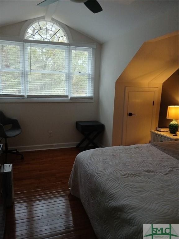 bedroom featuring ceiling fan, dark wood-type flooring, and vaulted ceiling