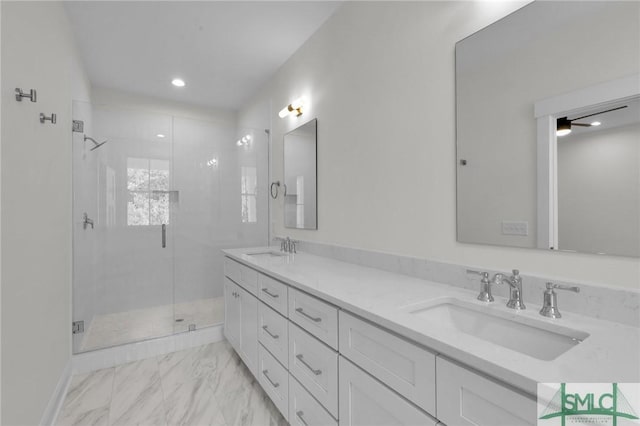 bathroom featuring vanity and a shower with door