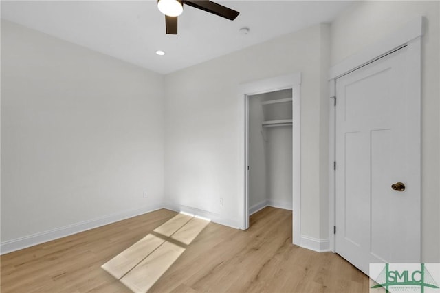 unfurnished bedroom featuring a closet, light hardwood / wood-style floors, and ceiling fan